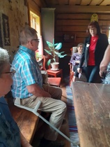 Näkymä pirtin sisältä Jorma, Anni ja Eira keinutuolissa